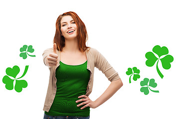 Image showing smiling teen girl with shamrock showing thumbs up