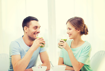 Image showing smiling couple having breakfast at home