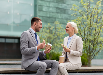 Image showing smiling businessmen with paper cups outdoors