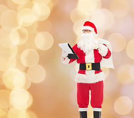 Image showing man in costume of santa claus with notepad and bag