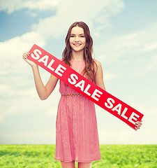 Image showing young woman in dress with sale sign