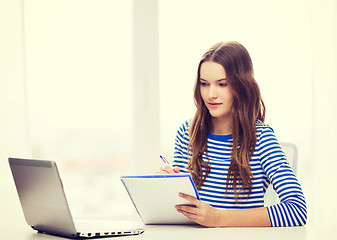 Image showing teenage girl laptop computer and notebook