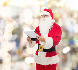 Image showing man in costume of santa claus with notepad