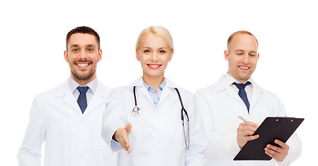 Image showing group of doctors making handshake gesture