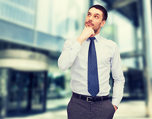 Image showing handsome businessman looking up