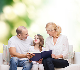 Image showing happy family with book at home