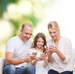 Image showing happy family with smartphones