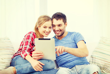 Image showing smiling couple with tablet pc computer at home