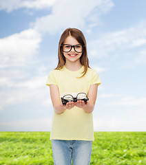 Image showing smiling cute little girl in black eyeglasses