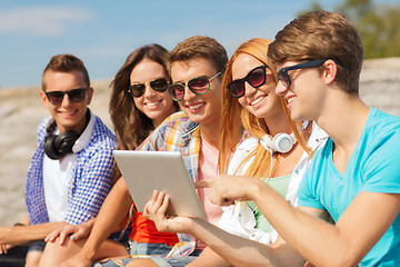 Image showing group of smiling friends with tablet pc outdoors