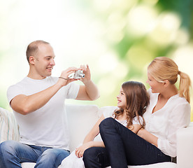 Image showing happy family with camera at home