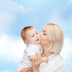 Image showing happy mother kissing smiling baby