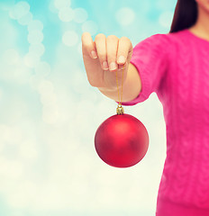 Image showing close up of woman in sweater with christmas ball