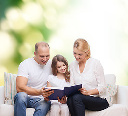 Image showing happy family with book at home