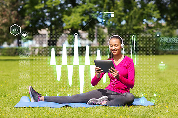 Image showing smiling woman with tablet pc outdoors