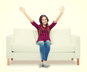 Image showing teenage girl sitting on sofa with headphones