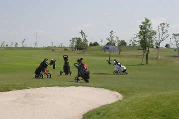 Image showing Golf bags in golf course