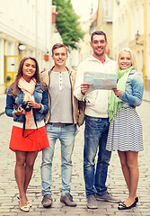 Image showing group of smiling friends with map and photocamera