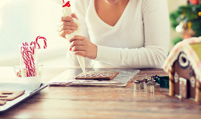 Image showing close up of woman making gingerbread houses