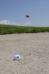 Image showing Golf ball in sand trap