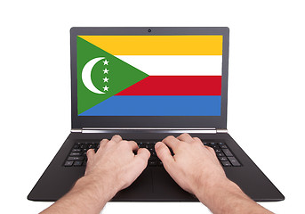 Image showing Hands working on laptop, Comoros