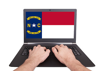 Image showing Hands working on laptop, North Carolina