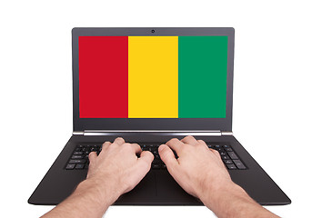 Image showing Hands working on laptop, Guinea