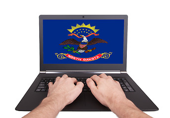 Image showing Hands working on laptop, North Dakota