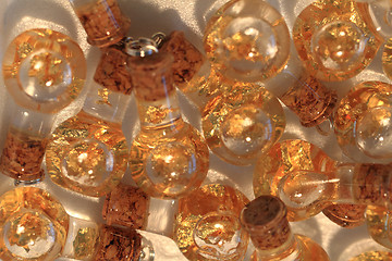 Image showing gold in the bottles of water 