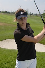 Image showing Female golfer playing golf