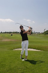 Image showing Female golfer playing golf