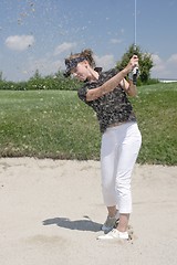 Image showing Female golfer playing