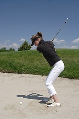 Image showing Female golfer playing