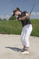 Image showing Female golfer playing