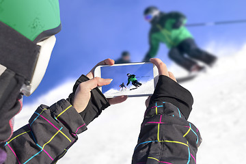 Image showing Photographed two skiers with cell phone