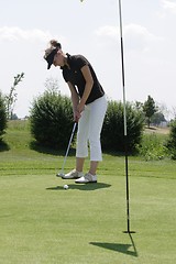 Image showing Female golfer playing