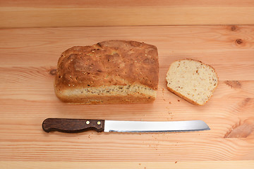 Image showing Fresh loaf of bread with a cut slice