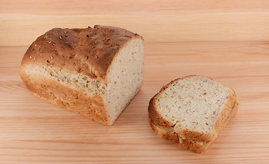 Image showing Cut loaf of freshly baked bread with a PB&J sandwich