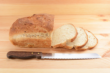 Image showing Three slices cut from a loaf of bread with a knife