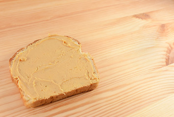 Image showing Peanut butter on a slice of bread