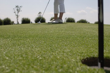 Image showing Female golfer playing