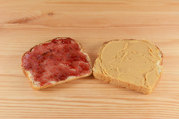 Image showing Slices of fresh bread with jelly and peanut butter