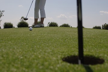 Image showing Female golfer playing