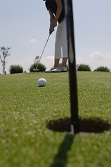 Image showing Female golfer playing