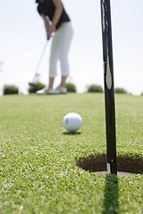 Image showing Female golfer playing