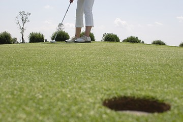 Image showing Female golfer playing