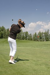 Image showing Female golfer playing