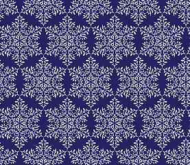 Image showing snowflakes on a dark blue background. seamless pattern