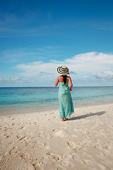 Image showing Girl walking along a tropical beach in the Maldives.