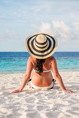 Image showing Girl walking along a tropical beach in the Maldives.